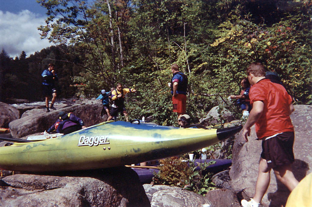 Bunch of boats and boaters on the bank of the river. (Category:  Paddling)