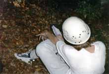 Sarah putting on climbing shoes. (Category:  Rock Climbing)