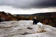 Sarah sitting on top of Peter's Kill at the end of the trip.  Watching a storm roll in. (Category:  Rock Climbing)