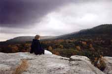 Sarah sitting on top of Peter's Kill at the end of the trip.  Watching a storm roll in. (Category:  Rock Climbing)