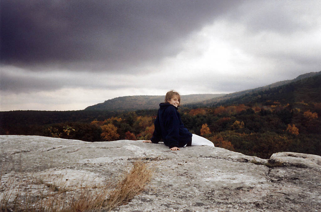 Sarah sitting on top of Peter's Kill at the end of the trip.  Watching a storm roll in. (Category:  Rock Climbing)