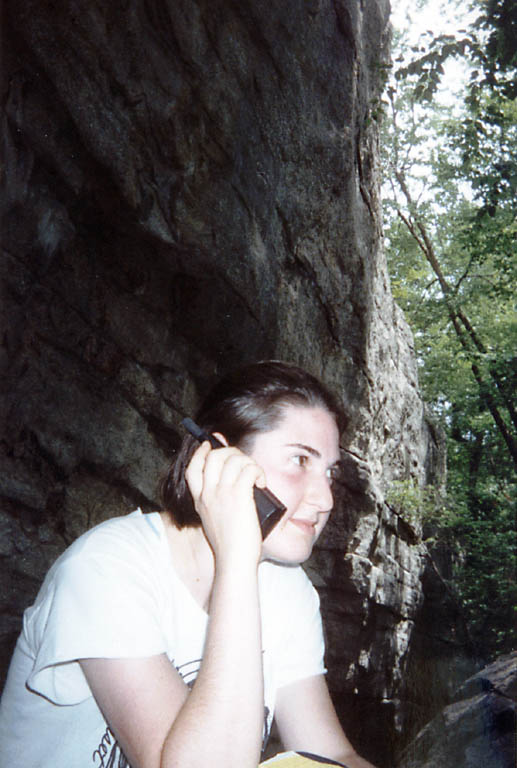 Lauren making a mandatory check-in call to her parents from the base of the cliffs at Lost City. (Category:  Rock Climbing)