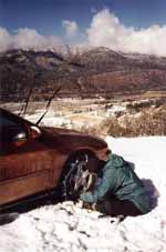 Putting chains on the rental car. (Category:  Skiing)