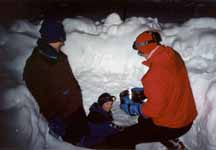 Ann, Joanna and me getting water from a stream flowing 10 feet below the surface of the snow. (Category:  Skiing)