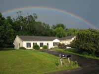 Biking home from Ithaca Fest, I got caught in a horrific downpour.  The reward was this amazing 180 degree rainbow when I reached home. (Category:  Residence)