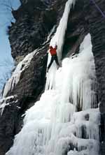 Climbing Playing Hooky.  Transitioning on to the big, overhanging icicle. (Category:  Ice Climbing)