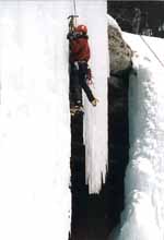 Rich transitioning from one icicle to another. (Category:  Ice Climbing)