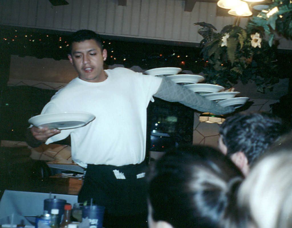 Waiter at a restaurant in Lexington balancing six dinners at one time. (Category:  Rock Climbing)