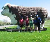 Posing by the giant cow.  That cow has been there for as long as I can remember. (Category:  Biking)