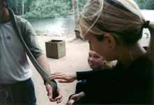 Anna somewhat reluctantly touching a Water Python (Category:  Travel)