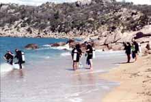 Scuba class heading into the ocean. (Category:  Travel)