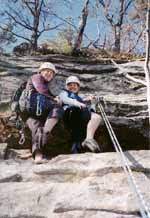 Heidi and Jen at the top of Frog's Head, showing some leg. (Category:  Rock Climbing)