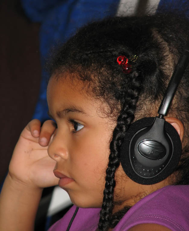 Sophia watching a movie on the airplane. (Category:  Travel)