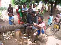 Chopping the tops off to get at the Madafu. (Category:  Travel)