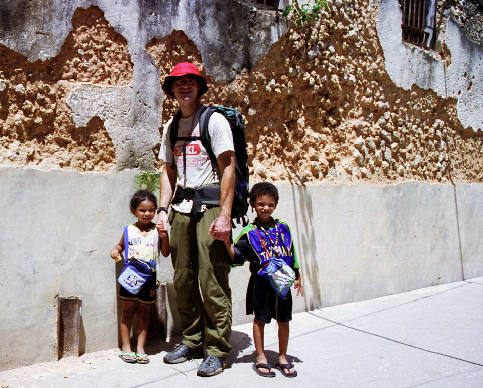 Sophia, me and Nassor in front of a coral wall. (Category:  Travel)