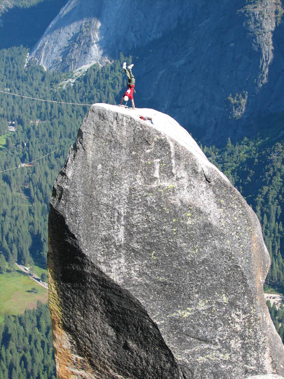 Ryan doing a handstand on top of Lost Arrow Spire. (Category:  Rock Climbing)