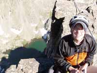 Alana at the summit of Petit Grepon.  Sky Pond visible 1000' below. (Category:  Rock Climbing)