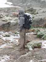 Ryan in the blizzard at the base of Petit Grepon. (Category:  Rock Climbing)