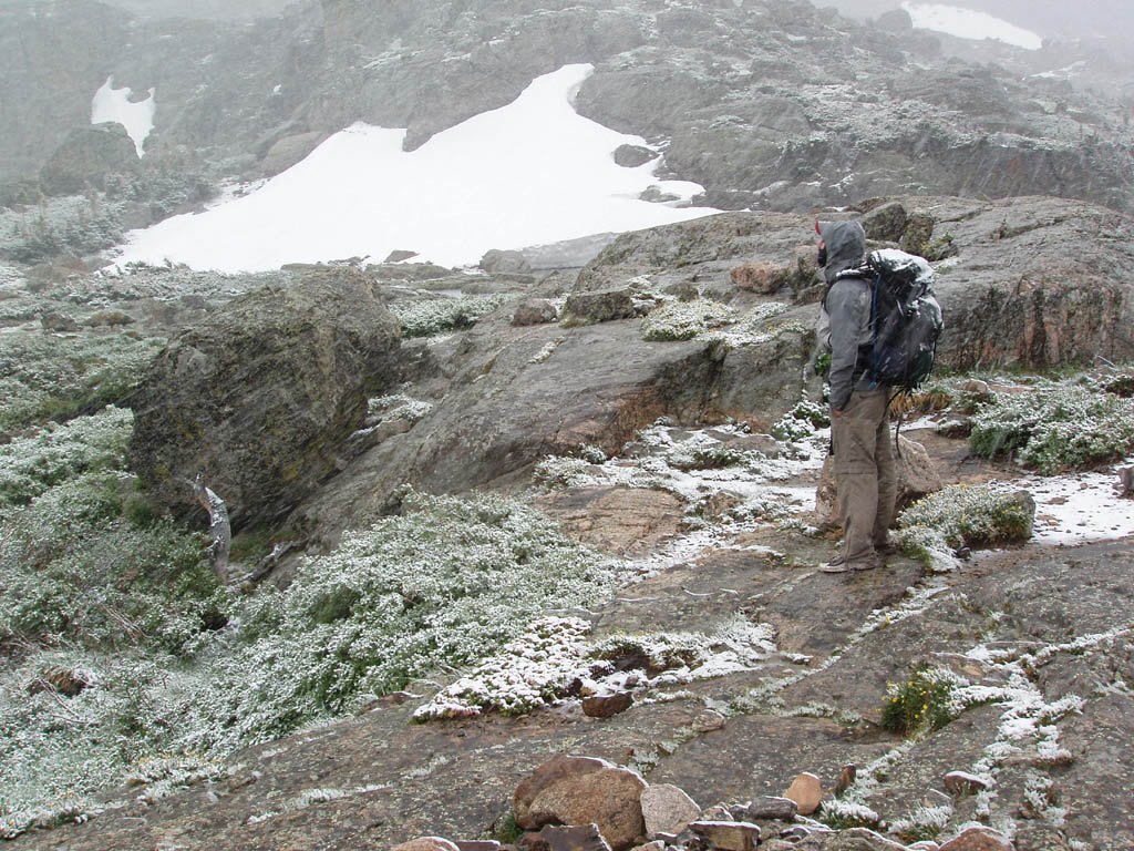 Ryan in the blizzard at the base of Petit Grepon. (Category:  Rock Climbing)