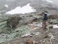 Ryan in the blizzard at the base of Petit Grepon. (Category:  Rock Climbing)