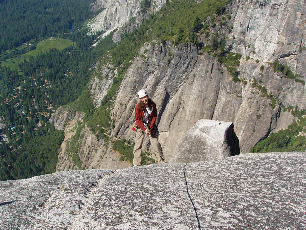 Jess starting to rappel down to the base of the spire. (Category:  Rock Climbing)