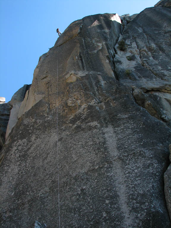 Jess starting to rappel down to the base of the spire as seen from my vantage at the base. (Category:  Rock Climbing)