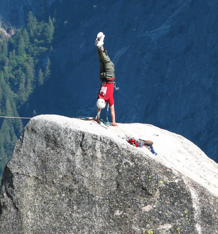 Ryan doing a handstand on top of Lost Arrow Spire. (Category:  Rock Climbing)