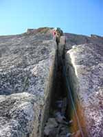 Starting to lead the long chimney on NE Ridge of Bugaboo Spire. (Category:  Rock Climbing)