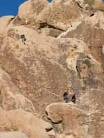 Aramy leading Coyote in the Bushes with Kristin belaying and Kenny hanging out on the starting ledge. (Category:  Rock Climbing)