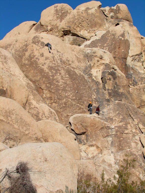 Aramy leading Coyote in the Bushes with Kristin belaying and Kenny hanging out on the starting ledge. (Category:  Rock Climbing)