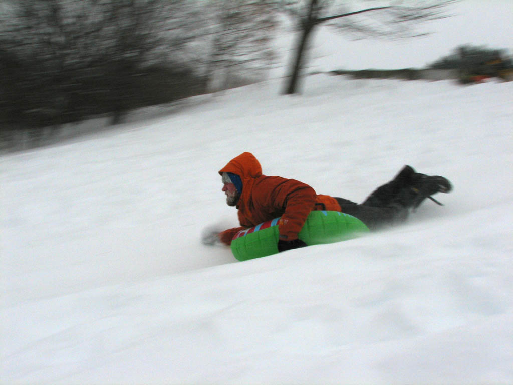 Greg sledding.  I really tried to get some good panning photos, but my hands got too cold.  This shot of Greg was the best of the bunch. (Category:  Skiing)