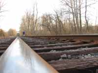 Julia walking down the railroad tracks. (Category:  Backpacking)