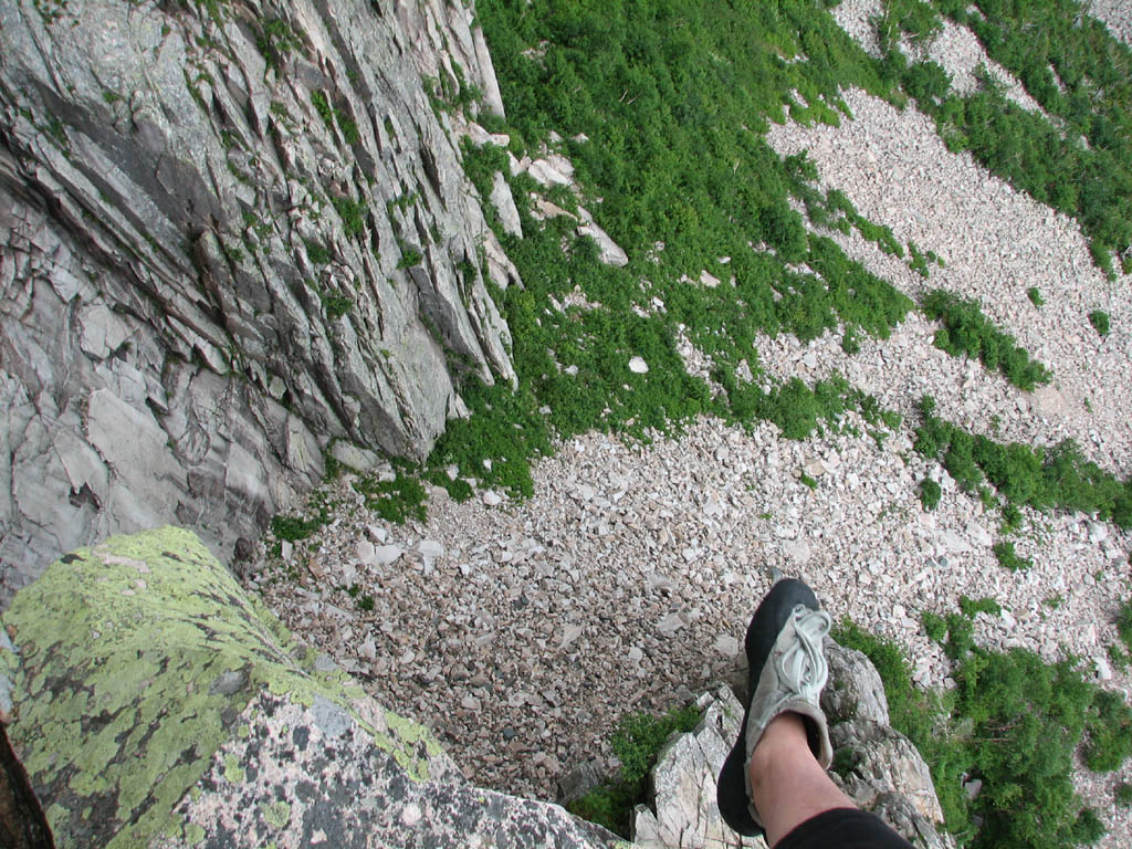 Lots of exposure up high.  Anna's foot dangling over a 400' drop. (Category:  Rock Climbing)