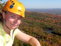 Kristin with fall colors below. (Category:  Rock Climbing)