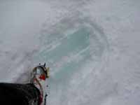 Keith with his foot on one of the blocks of ice that nearly killed him. (Category:  Ice Climbing)