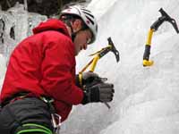 Placing a screw. (Category:  Ice Climbing)