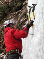 Placing a screw. (Category:  Ice Climbing)