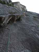 Guy leading p3 of Snake.  He is going to fall off the slab and small vertical section just above him. (Category:  Rock Climbing)