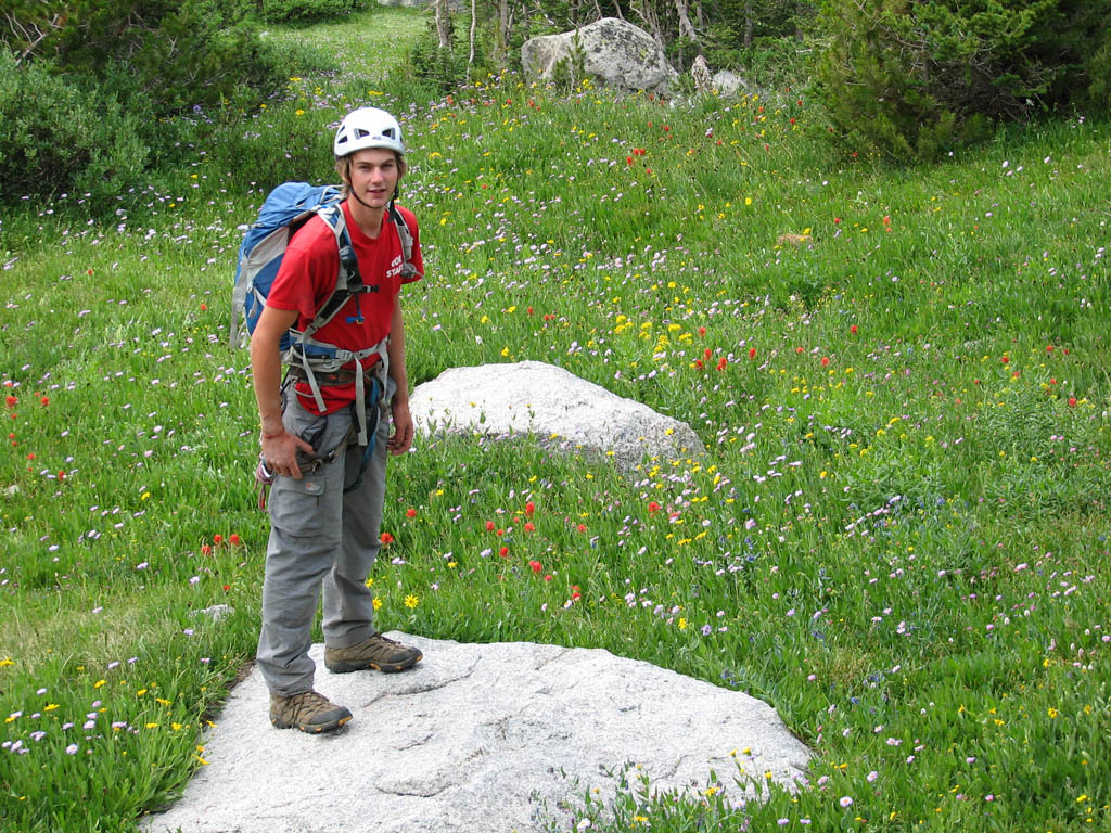 Guy amidst the wildflowers at the base of Haystack. (Category:  Rock Climbing)