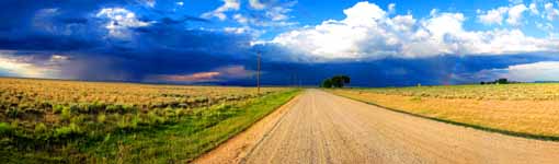 Driving 50 miles away from the Wind River Range.  We are still on dirt roads and the terrain has gone from alpine mountains to flat plains. (Category:  Rock Climbing)