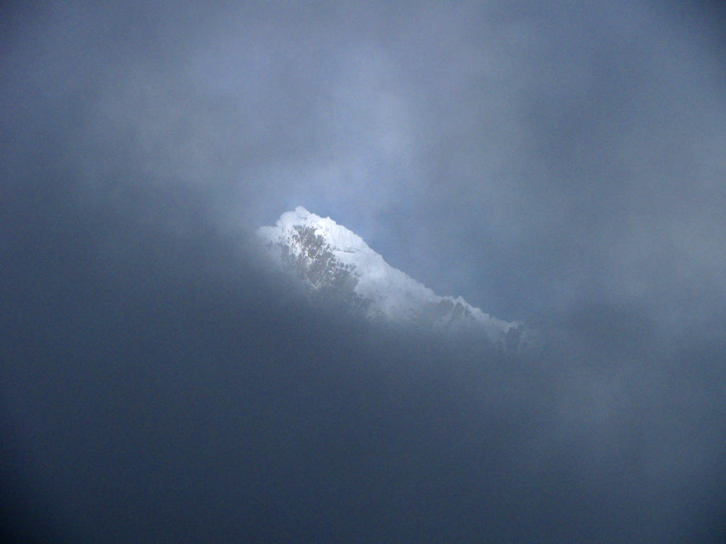 Alpamayo peaking out through the clouds. (Category:  Travel)