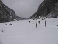 Crossing Avalanche Lake.  The winds were gusting to around 40mph here. (Category:  Ice Climbing)