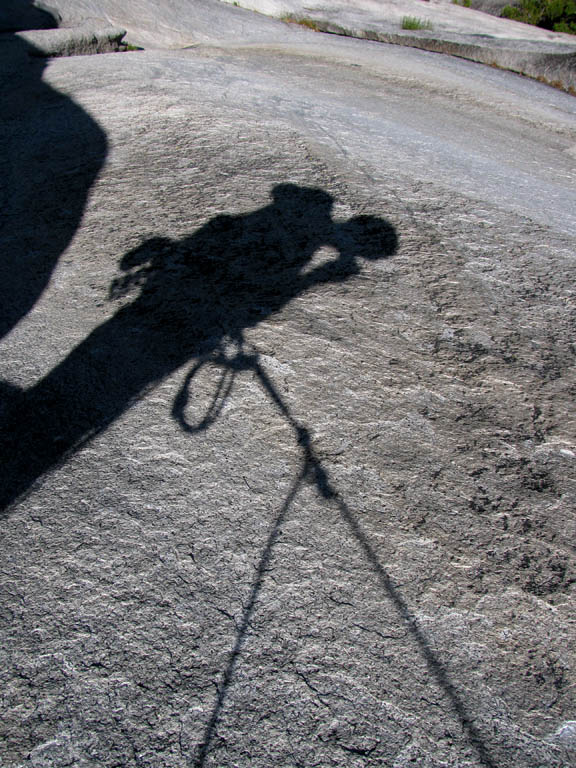 Guy's shadow during the pendulum. (Category:  Rock Climbing)