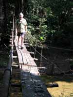 Mark walking across a rickety old foot bridge. (Category:  Travel)