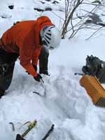 Guy excavating a comfy seat... (Category:  Ice Climbing)