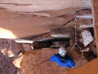 Guy looking down at the squeeze chimney I very much wish we had avoided. (Category:  Rock Climbing)