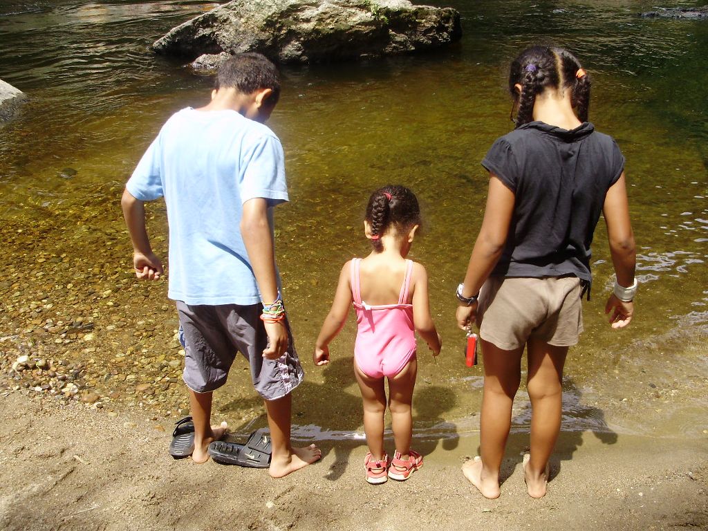 Nassor, Johari and Sophia down at the river. (Category:  Family)
