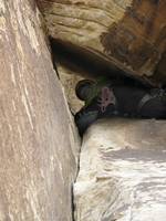 Aramy squeezing through the chockstone. (Category:  Rock Climbing)