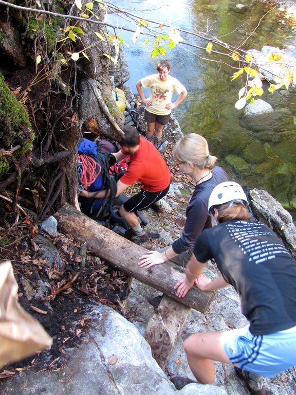 Passing packs down to the stream crossing. (Category:  Rock Climbing)