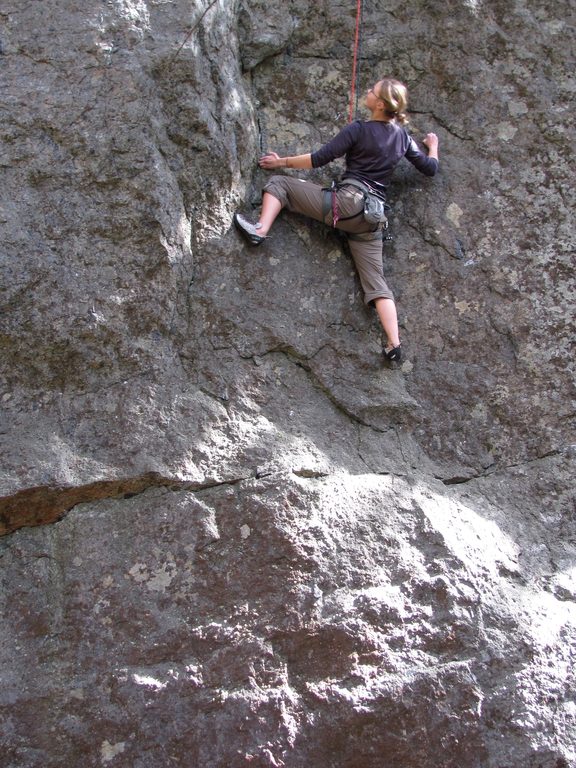 Emily at the crux of James and the Giant Boulder. (Category:  Rock Climbing)